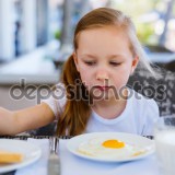 Little girl eating breakfast